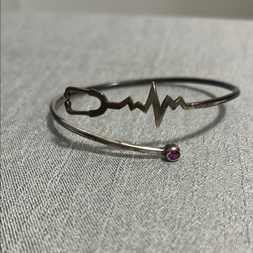 Silver Bracelet with Heartbeat Design and Pink Gem